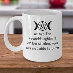 a white coffee mug with the words we are the granddaughters of the witches you weren't able to burn