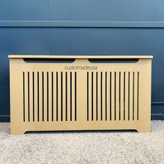 a cardboard box sitting on the ground next to a blue wall