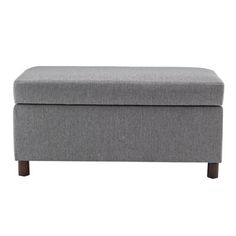 a gray ottoman with wooden legs on a white background