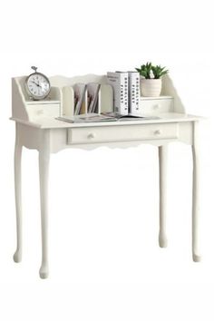 a small white desk with books and an alarm clock on it's side table