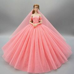 a barbie doll wearing a pink dress and veil