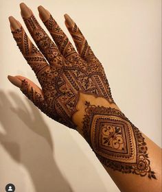 a woman's hand is decorated with hennap and intricate designs on it