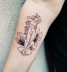 a woman's arm with a tattoo on it and flowers around the arm area