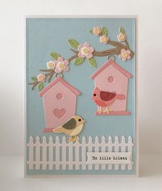 a handmade card with two birds and birdhouses