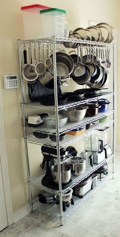 a rack filled with lots of pots and pans