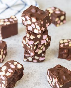 several pieces of chocolate are stacked on top of each other with pink and white hearts