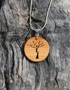 "This very unique hand-carved Tree of Life pendant will be made for you, or a loved one, in my studio on the West of Ireland. Adorned with mother of pearl & silver inlays, this detailed Celtic Tree pendant features a piece of Yew wood. Considered one of the Sacred trees in the Celtic world, the Yew has long been associated with immortality & longevity. As a consequence, warriors and poets alike were often called after it. Indeed, Eoghan remains one of the more popular Irish names in mode Irish Yew, Spiritual Carved Round Pendant Necklaces, Carved Natural Wood Nature-inspired Jewelry, Carved Natural Wood Necklaces, Carved Wood Necklace Pendants, Wooden Tree Of Life Pendant, Carved Tree, Irish Names, Yew Wood