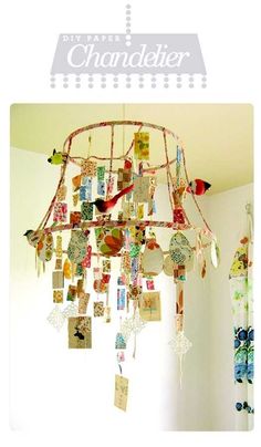 a chandelier with pictures hanging from it's sides and birds on the top