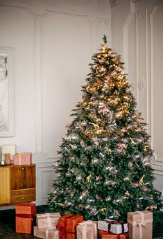 a decorated christmas tree with presents under it