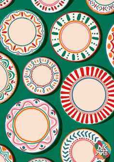 many different colored plates on a green background