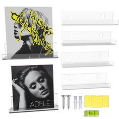 three acrylic display cases with yellow and black graphics on the front, one for adelec