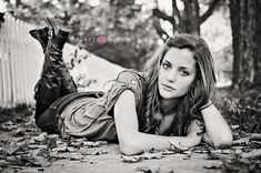 a woman laying on the ground next to a dog