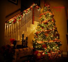 a decorated christmas tree sitting under a banister