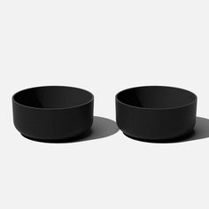 two black bowls sitting next to each other