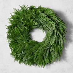 a green wreath is hanging on the wall