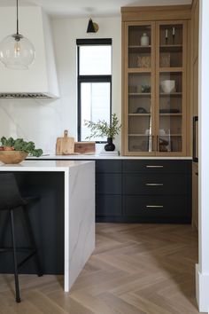 the kitchen is clean and ready to be used for cooking or baking, with black cabinets and white marble countertops