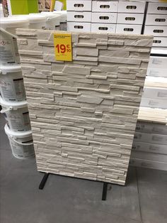 a stack of white boxes sitting on top of a floor next to stacks of drawers