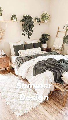 a bedroom with white and grey bedding, potted plants on the wall and wooden flooring