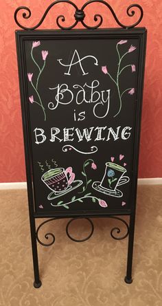 a baby is brewing sign in front of a wall