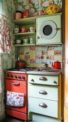 an old fashioned stove and oven in a kitchen with floral wallpaper on the walls