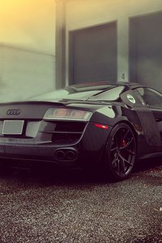 a black sports car parked in front of a building