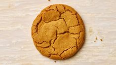 a close up of a cookie on a white surface with some brown stuff around it