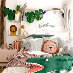 a bed with pillows and stuffed animals on it