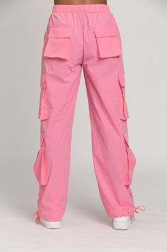 NEW Limited Edition & custom designed Pink Parachute Pants! Not only did we spend months designing these amazing cargo style pants, but we PERFECTED them in the process! These pants are insanely versatile due to their lightweight material and trendy style. They feature adjustable ankle cuffs that you can leave wide or tie up for a jogger look. The elastic waist-band allows for a comfortable fit and the multiple pockets provide great functionality. These pants easily can be worn for any workout o Pink Utility Cargo Pants, Pink Utility Cargo Pants With Pockets, Pink Utility Cargo Style Bottoms, Pink Wide Leg Cargo Pants, Pink Baggy Cargo Pants, Pink Wide-leg Cargo Pants, Pink Utility Cargo Pants For Streetwear, Pink Cargo Style Trousers, Pink Cargo Style Pants For Streetwear