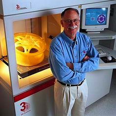 a man standing in front of an open machine