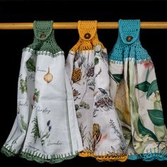 three scarves hanging on a clothes line with pineapples and acorns