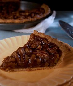 a slice of pecan pie on a paper plate