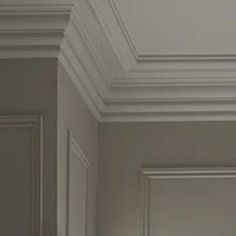 an open door in a room with white walls and molding on the trimmings