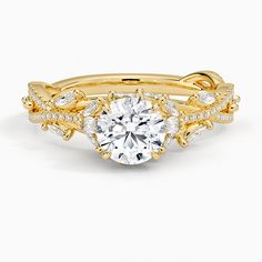 a yellow gold engagement ring set with an oval cut diamond surrounded by small white diamonds