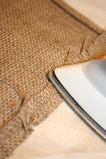 an iron sitting on top of a piece of burlock next to a cloth