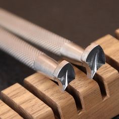 three pieces of wood with metal tips on them