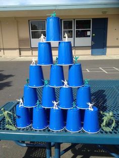 there are many blue buckets stacked on top of each other