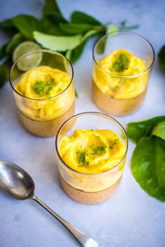 three small glasses filled with food on top of a table