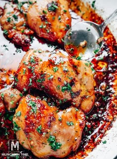 the chicken is covered in sauce and garnished with parsley