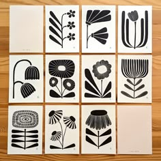 six black and white flower prints on wood