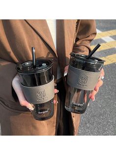 two people holding coffee cups in their hands