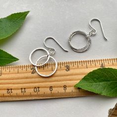 Elegant, Light & Sparkly Double Hoop Earrings -- Beautiful with all of the milestone necklaces. These are perfect for everyday wear.✦ All metal is bright sterling silver.✦ Circles have been given a unique hammered texture, and are organically shaped.✦ Each jump ring has been soldered closed for extra handmade quality.✦ Earrings are 1 1/4" long, including the french hook ear wires✦ Largest circles are 5/8" wide. Nickel-free Sterling Silver Hoop Earrings For Everyday, Hypoallergenic Open Circle Hoop Earrings For Gift, Adjustable Sterling Silver Hoop Earrings With Ear Wire, Adjustable Nickel-free Sterling Silver Hoop Earrings, Sterling Silver Open Circle Earrings For Everyday, Sterling Silver Everyday Open Circle Earrings, Minimalist Cadmium-free Sterling Silver Earrings, Everyday Sterling Silver Hammered Hoop Earrings, Small Hoop Hammered Sterling Silver Jewelry