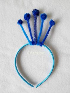 three blue headbands with small flowers on each side, and one is made out of plastic