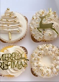 four cupcakes decorated with white frosting and gold decorations