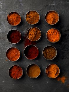 several bowls filled with different types of spices