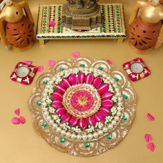 a table topped with lots of decorations on top of a brown table covered in pink and green flowers