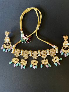 Beautiful 3pcs Choker Set with Cloisonne Enamel paint and sliver folied Polki and Kundan with Monalisa Beads Item : Necklace with earring Color : Gold Polish Finish Length of necklace : 6 inches (without the adjustment tie)Width of necklace : 2.2 inches Length of Earrings : 2.5inches Width of Earnings - 1.2 inches Shop Polices -- Final Sale, No Return, No exchange - All are jewelry is handmade hence there is little inconsistency or small marks due to handmaking. These are not considered as defec Handmade Adjustable Jewelry Sets For Festive Season, Traditional Beaded Sets For Festive Season, Traditional Festive Beaded Sets, White Bohemian Jewelry Sets For Festive Occasions, Festive Traditional Beaded Sets, Handmade Multicolor Kundan Jewelry Sets, Multicolor Stone Work Beaded Necklaces For Festive Occasions, Festive Multicolor Stone Work Beaded Necklaces, Traditional Adjustable Jewelry Sets For Festive Occasions