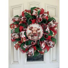 a christmas wreath on the front door with an image of a pig and holly leaves