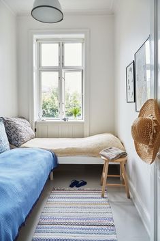 a bedroom with white walls and blue bedding