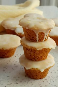 a stack of cupcakes sitting on top of a table next to sliced bananas