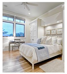 a bedroom with hardwood floors and white walls